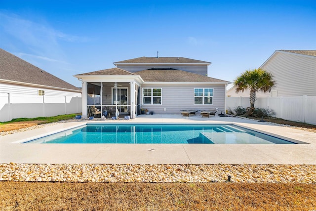 view of swimming pool featuring a sunroom and a patio