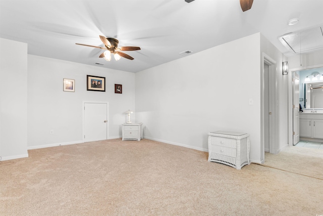 carpeted spare room with ceiling fan