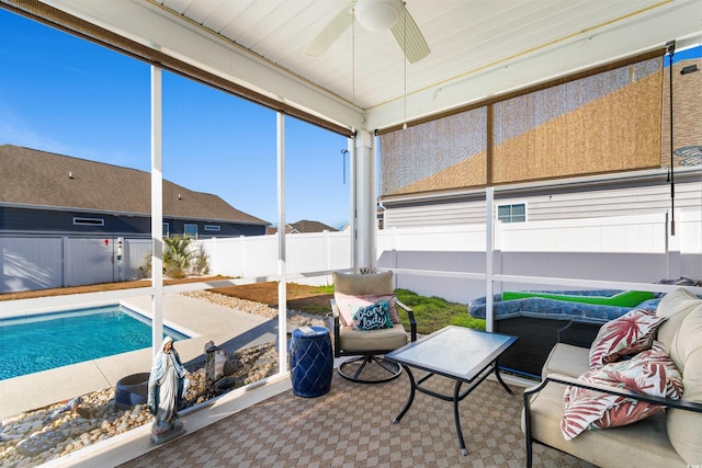 sunroom / solarium featuring ceiling fan