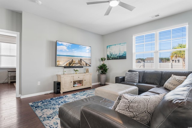 living room with dark hardwood / wood-style flooring and ceiling fan