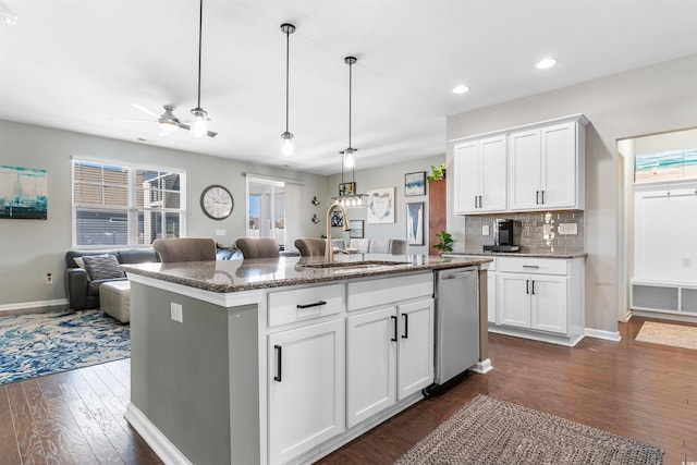 kitchen with white cabinetry, a kitchen island with sink, and stainless steel dishwasher