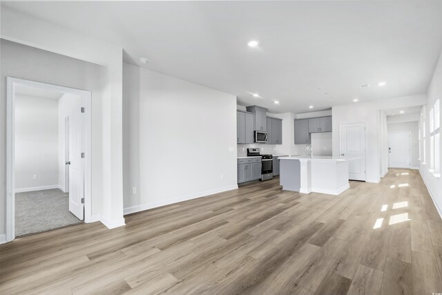 2039 Copper Creek Loop, Longs, SC 29568 - unfurnished living room with sink and light hardwood / wood-style floors