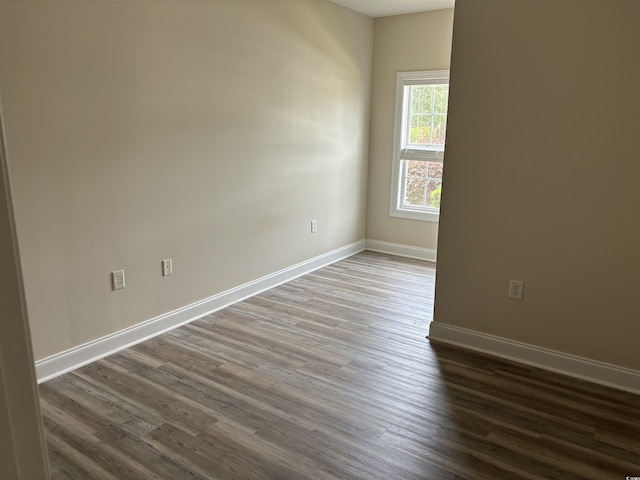 spare room with dark hardwood / wood-style floors