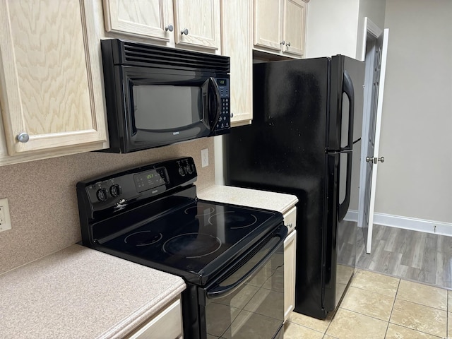 kitchen featuring light tile patterned floors and black appliances