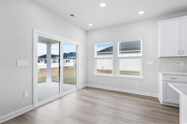 unfurnished dining area with light hardwood / wood-style floors