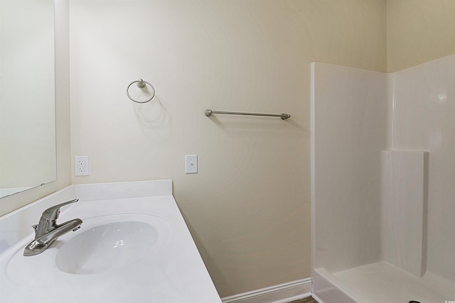 bathroom featuring a shower and sink