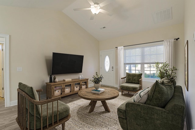 living room featuring ceiling fan, hardwood / wood-style floors, and lofted ceiling