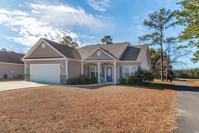 ranch-style home with a porch and a garage