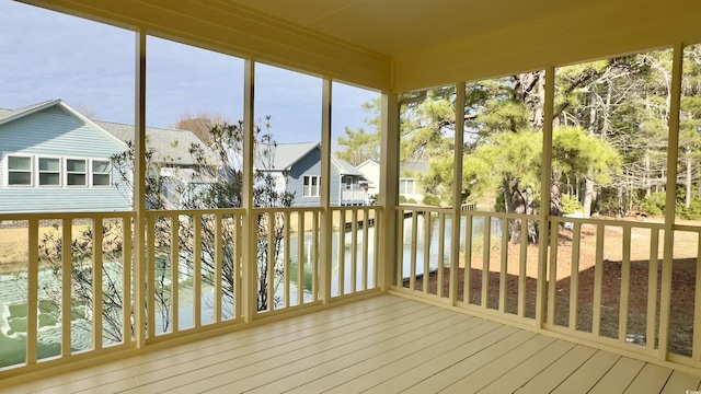 unfurnished sunroom with a water view and a healthy amount of sunlight