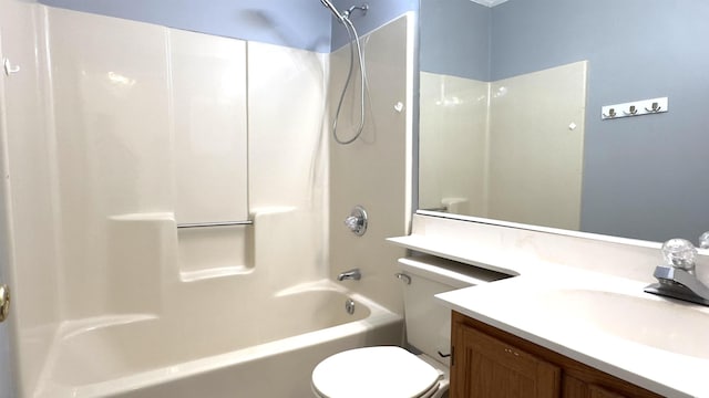 full bathroom with bathing tub / shower combination, vanity, and toilet