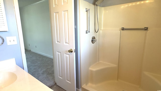 bathroom with a shower and vanity