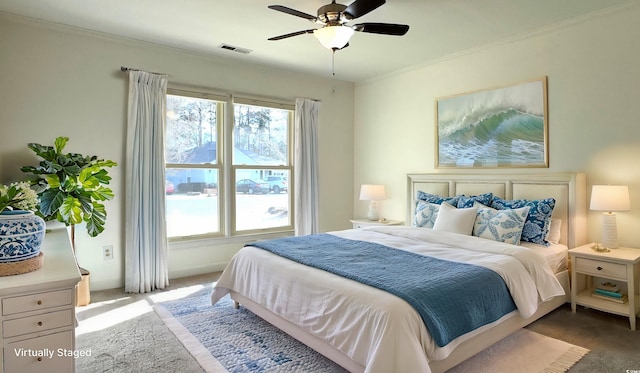 carpeted bedroom with ceiling fan, ornamental molding, and multiple windows