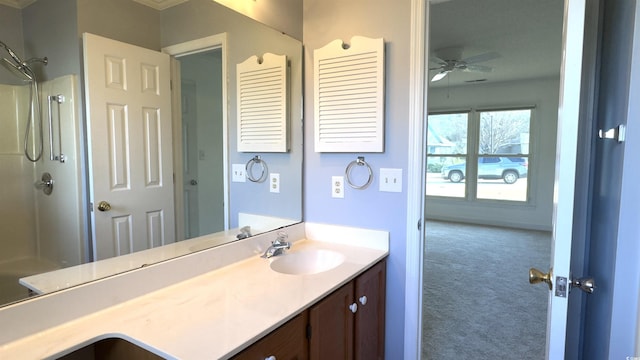 bathroom featuring ceiling fan, vanity, and a shower