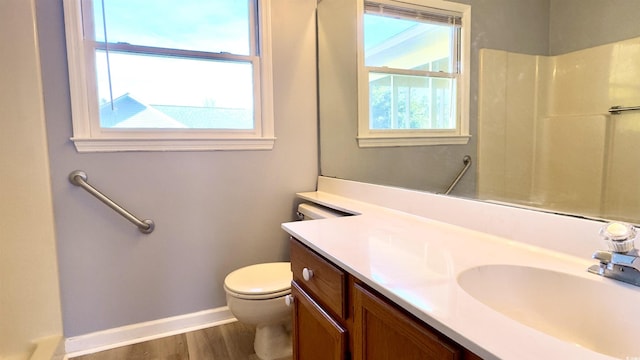 bathroom featuring walk in shower, wood-type flooring, toilet, and vanity