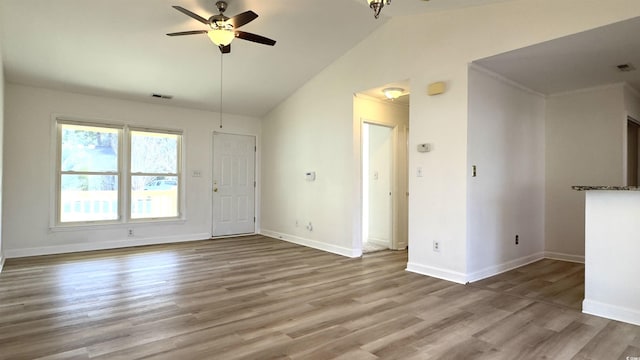 empty room with wood-type flooring, vaulted ceiling, and ceiling fan