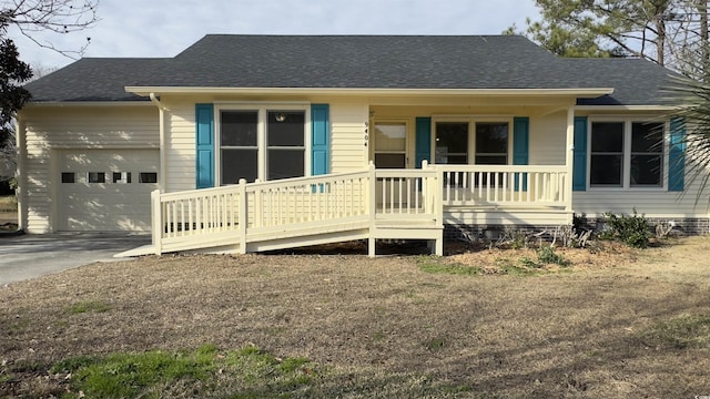 view of front of property featuring a garage and a porch