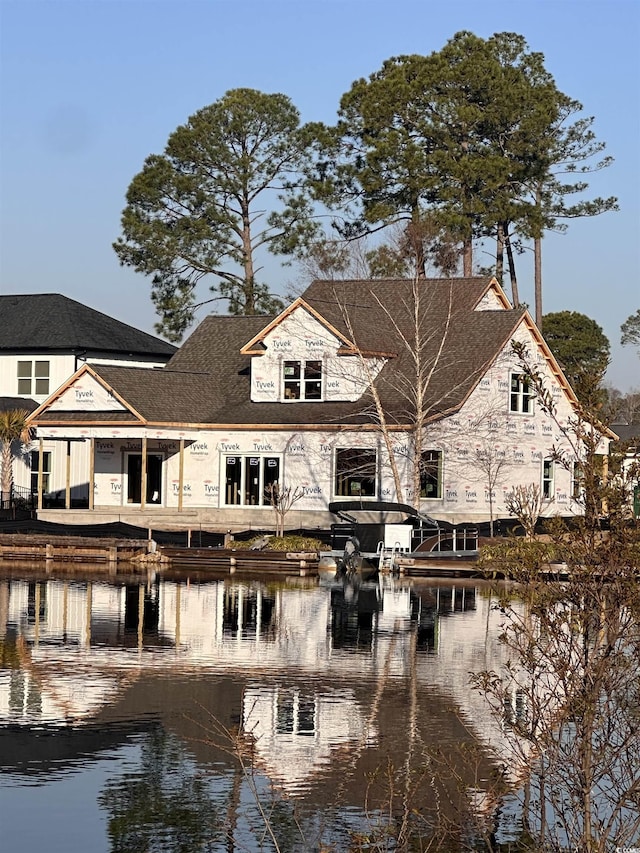 back of property with a water view