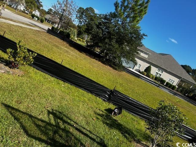 view of property's community with a lawn