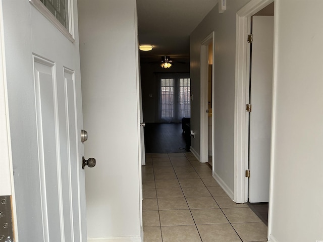 hall featuring light tile patterned floors