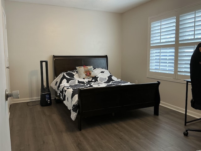 bedroom featuring dark hardwood / wood-style floors and multiple windows