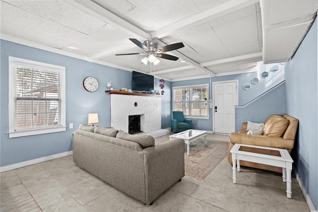 tiled living room with ceiling fan, a fireplace, beamed ceiling, and coffered ceiling