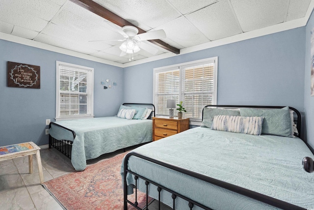 tiled bedroom featuring a paneled ceiling and ceiling fan