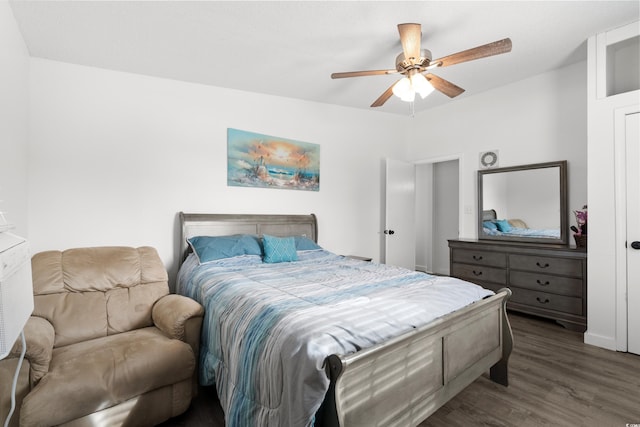 bedroom with dark hardwood / wood-style floors and ceiling fan