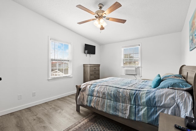 bedroom featuring wood-type flooring, cooling unit, ceiling fan, and lofted ceiling