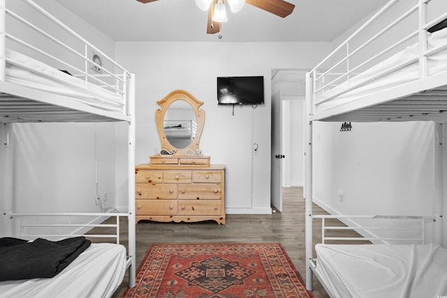 bedroom with dark hardwood / wood-style floors and ceiling fan