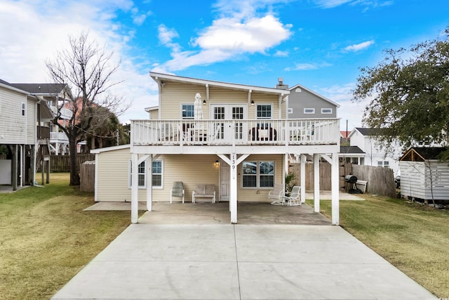 rear view of property featuring a yard and a deck