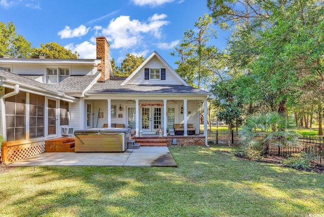 rear view of house with a lawn, cooling unit, ceiling fan, a patio, and a hot tub