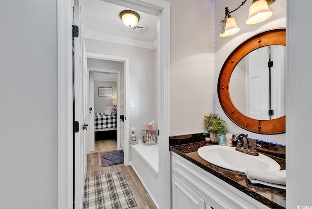 bathroom featuring vanity and crown molding