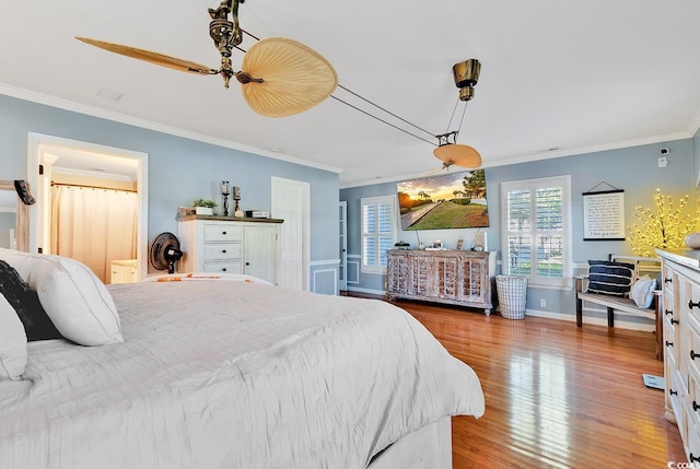 bedroom featuring hardwood / wood-style flooring, ceiling fan, and ornamental molding