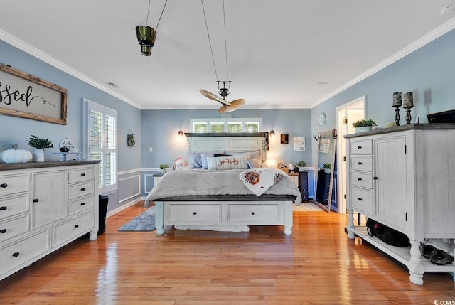 bedroom featuring ceiling fan, light hardwood / wood-style flooring, and ornamental molding