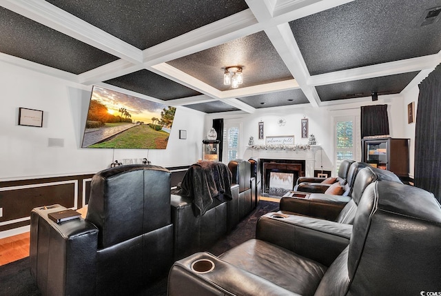 home theater with hardwood / wood-style floors, beam ceiling, crown molding, and coffered ceiling