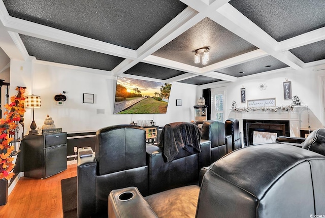 cinema room with beamed ceiling, light hardwood / wood-style floors, and coffered ceiling