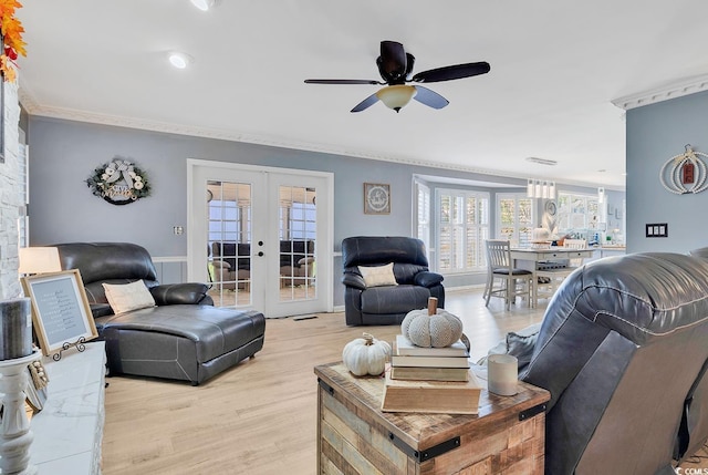 living room with french doors, light hardwood / wood-style floors, ceiling fan, and crown molding