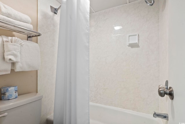 bathroom with shower / tub combo and toilet