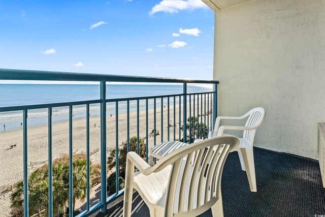 balcony featuring a beach view and a water view