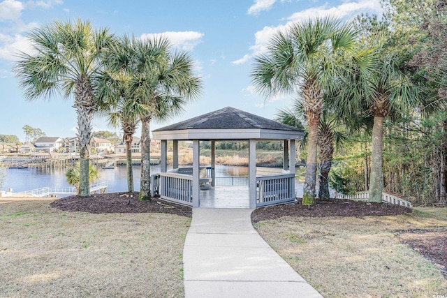 dock area with a lawn and a water view