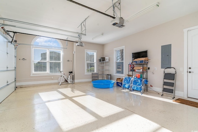 garage featuring electric panel and a garage door opener