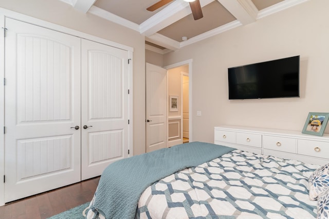 bedroom featuring ceiling fan, crown molding, beam ceiling, dark hardwood / wood-style floors, and a closet