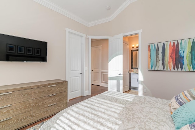 bedroom with hardwood / wood-style floors, lofted ceiling, crown molding, and ensuite bath