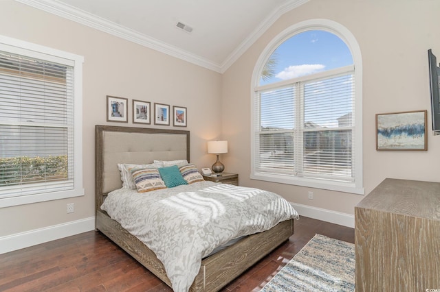 bedroom featuring dark hardwood / wood-style flooring, lofted ceiling, and ornamental molding