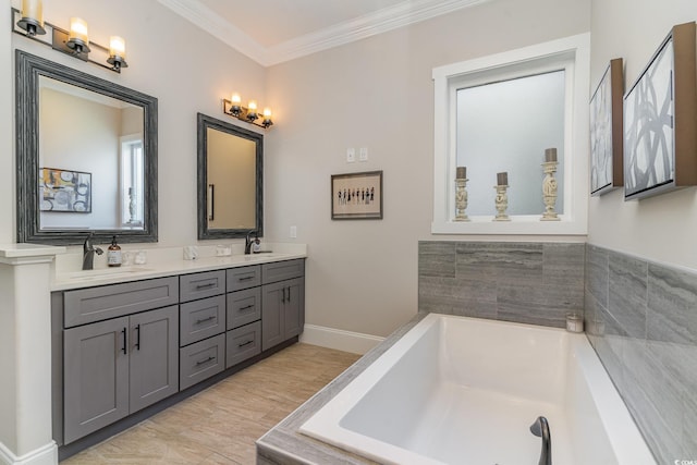 bathroom featuring vanity, a bath, and crown molding