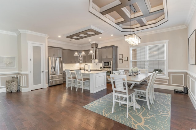 dining space featuring beamed ceiling, crown molding, coffered ceiling, and sink