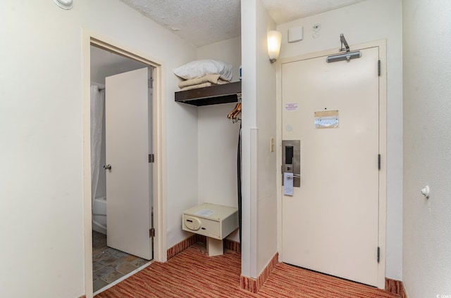 corridor featuring a textured ceiling