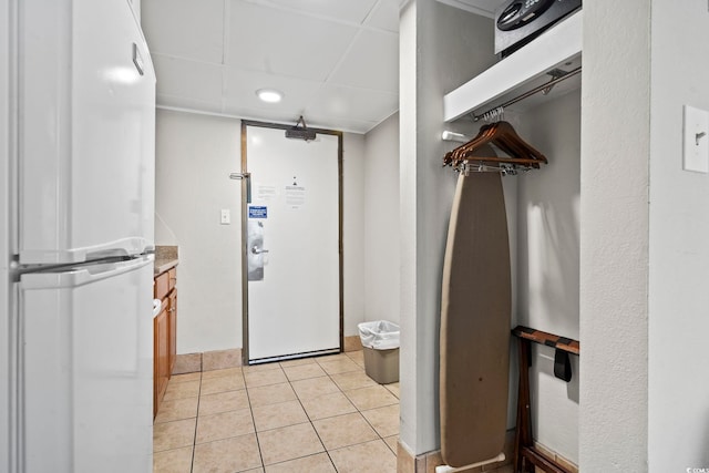 interior space with a paneled ceiling, tile patterned flooring, and vanity