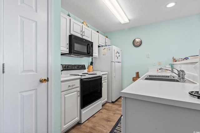 kitchen featuring a textured ceiling, white appliances, sink, white cabinets, and light hardwood / wood-style floors