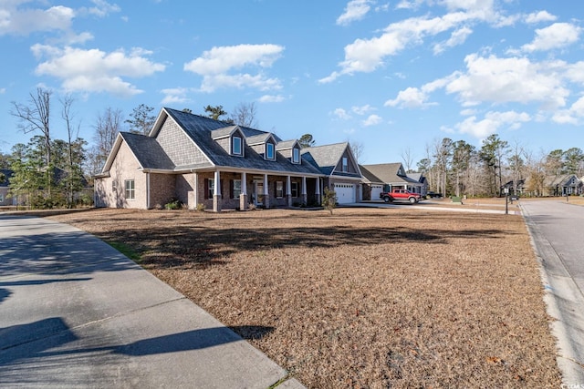 cape cod-style house with a porch and a garage